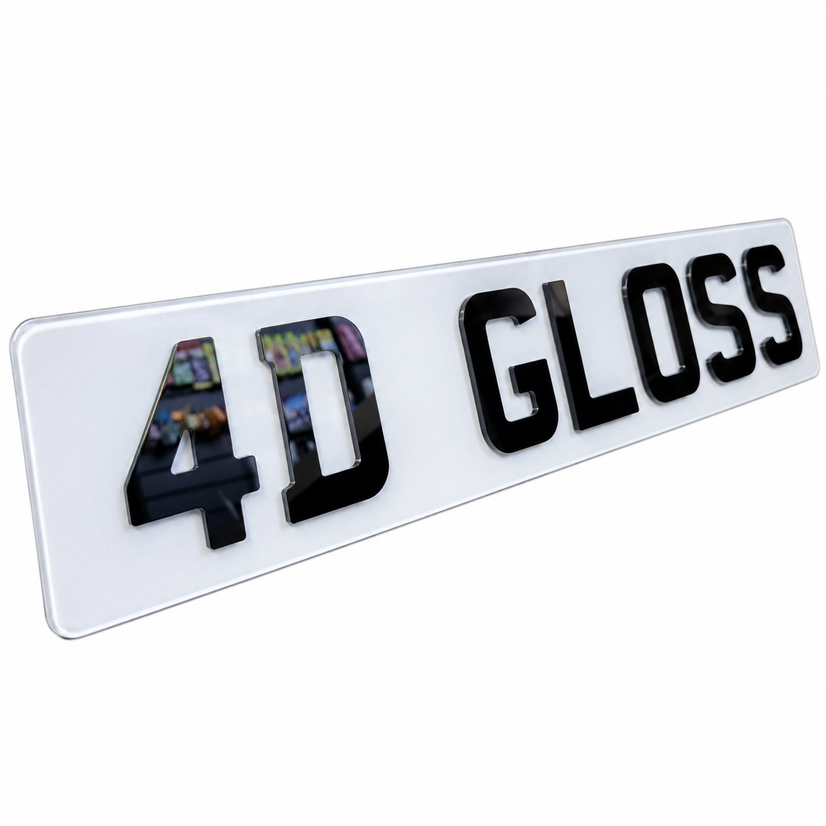 A glossy white rectangular license plate badge with raised black lettering reading '4D GLOSS' on a plain white background.