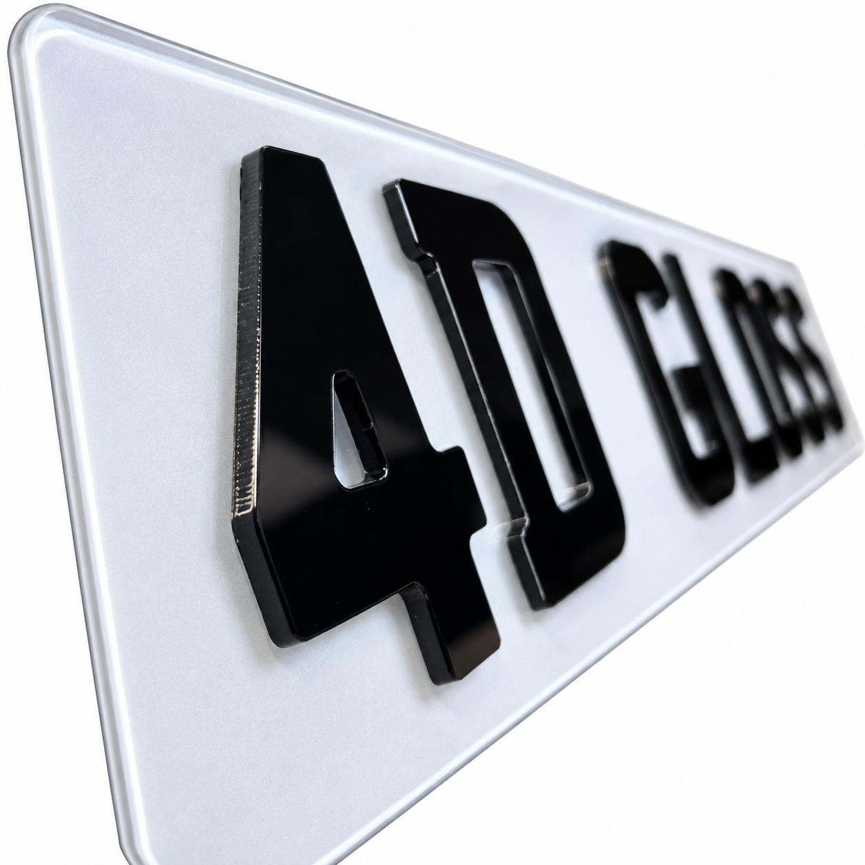 A close-up angled shot of a glossy white license plate featuring raised black characters reading '40 GLSS'.