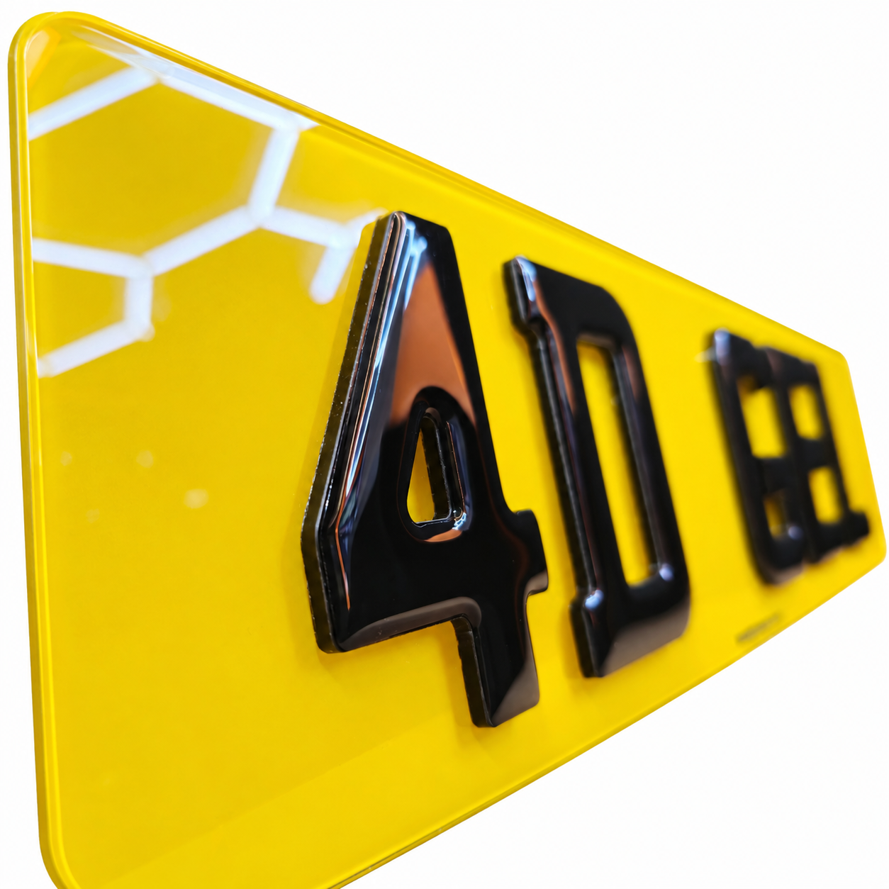 A close-up of a bright yellow license plate with glossy black raised numbers reading 4D GEL.